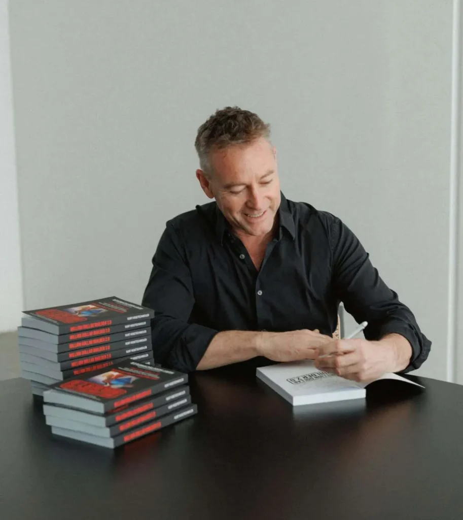 Kurt Hegetschweiler signing copies of Million Dollar Builder 2.0
