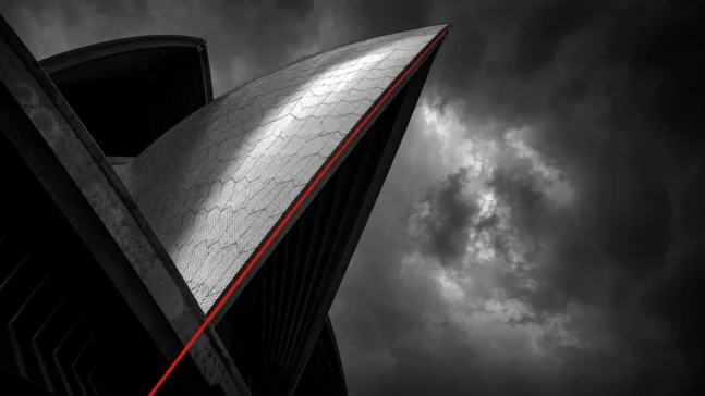The Sydney Opera House sails against a dark sky